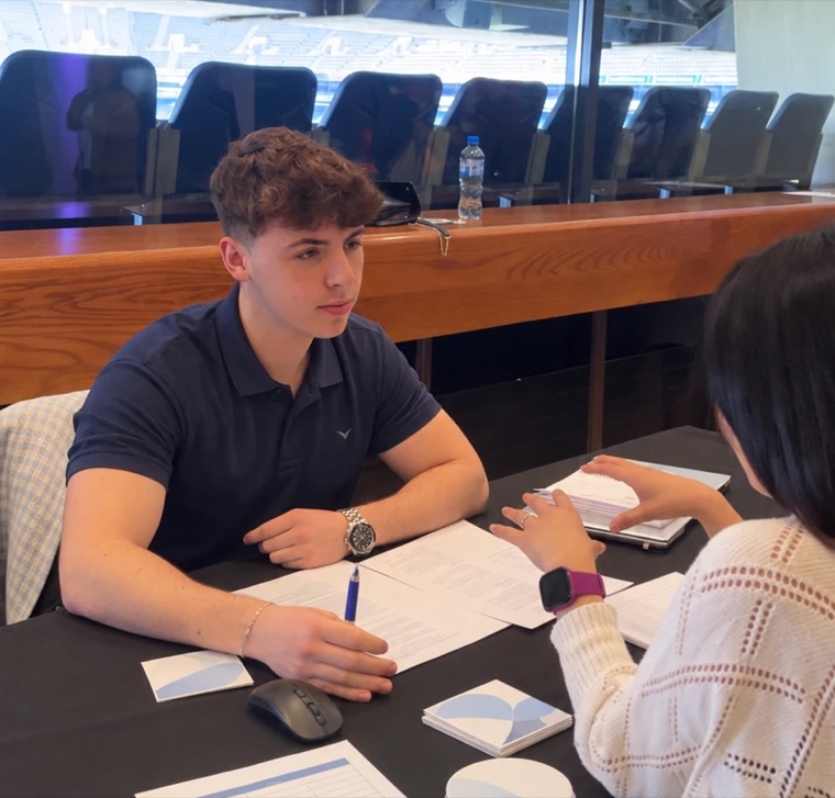 Dylan Corrigan at a table going through a CV with a client